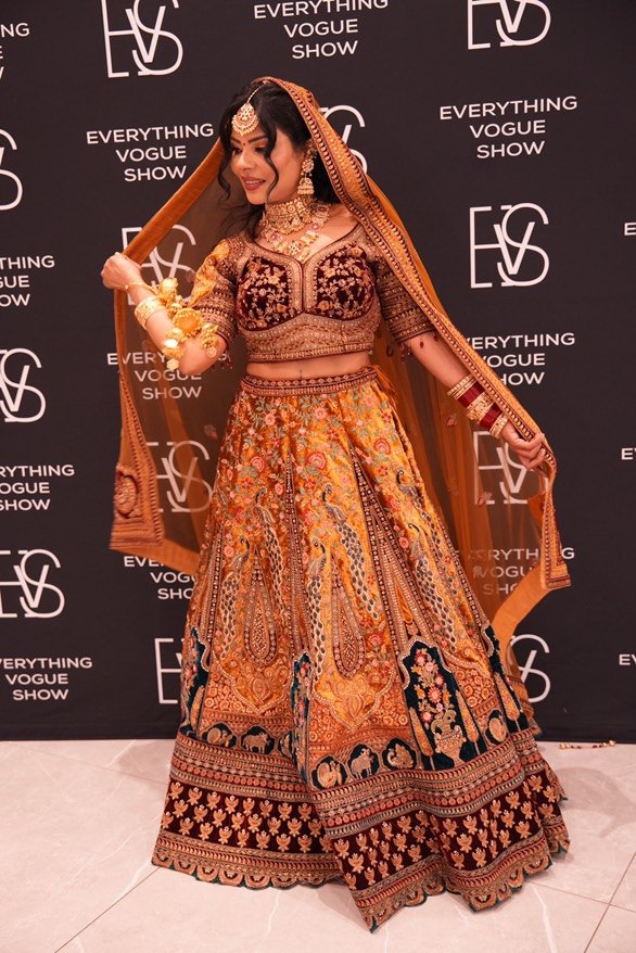 South Asian bride, ornate lehenga, veil in motion